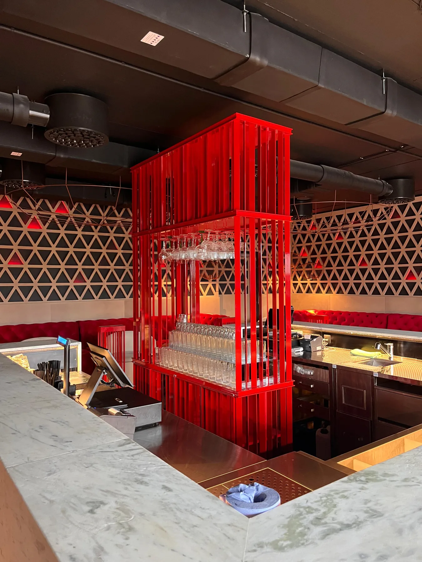 Red metal glass rack in the ExPorto bar interior