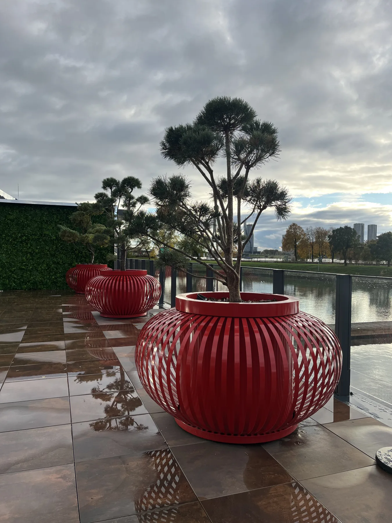 Line of red ribbed planters beside the water at ExPorto