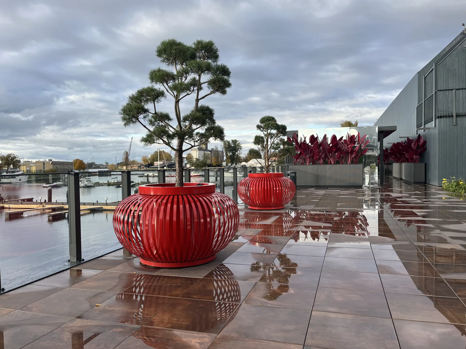 Red ribbed metal planters on the ExPorto waterfront terrace