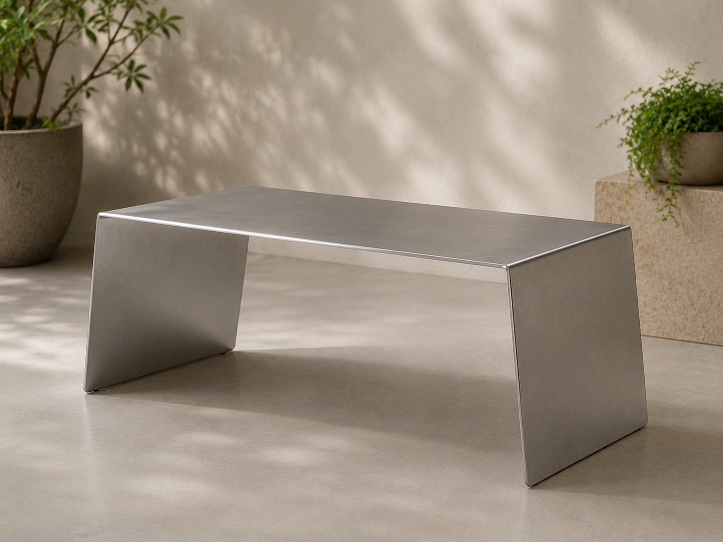 WE FORM SPACE Matt stainless steel table with angled side supports